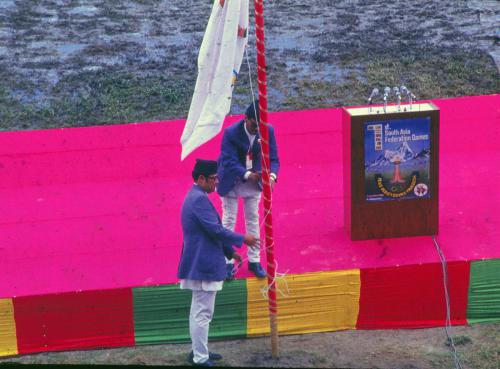 Minister of Education, Culture & Sports, Fateh Singh Tharu hoisting the 1st South Asia Games Flag assisted by Nepal Olympic Committee Member Subarna Chhetri at the Dashrath Rangashala, Kathmandu