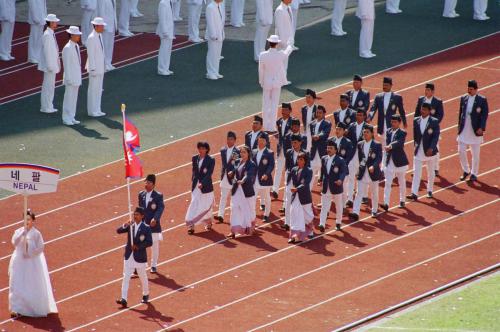 Chef-de-mission of Nepali contingent Indu Bahadur Shahi Leads the march past during the 24th Summer Olympics, Seoul, South Korea 1988. The flag-bearer of the national flag is Nepal's ace marathon runner, Baikuntha Manandhar