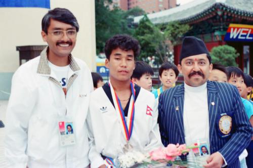 The President of Nepal Olympic Committee Sharad Chandra Shaha (right) with Bidhan Lama (centre) who bagged the bronze medal in Taekwondo (demonstration game).  Also seen in the picture is the Secretary General of Nepal Olympic Committee Digamber Suwal (left)