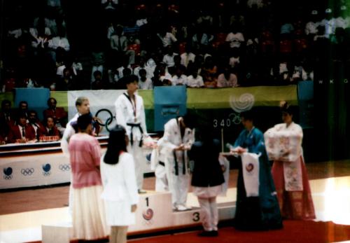 President of Nepal Olympic Committee Sharad Chandra Shaha awarding medals to Taekwondo players during the 24th Summer Olympics, Seoul, South Korea 1988