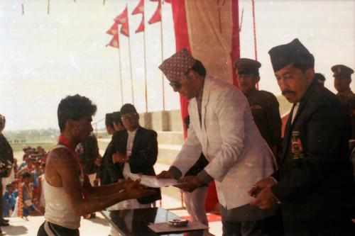 Patron of the National Sports Council HRH Prince Dhirendra awarding medal/certificate to a player during the 3rd National Games, Birgunj. Seen during the occasion are Member Secretary of the National Sports Council Sharad Chandra Shaha (right) and National Sports Council member Subarna Chhetri (centre)