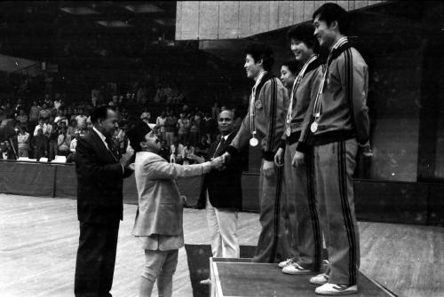 President of Nepal Olympic Committee Sharad Chandra Shaha congratulating the medal winning Chinese team during the Delhi Asian Games