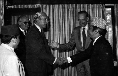 Prime Minister Lokendra Bahadur Chand (right) greets IOC member and Veteran Mountaineer Maurice Herzog during his visit to Nepal (Oct 26, 1985). President of Nepal Olympic Committee Sharad Chandra Shaha (left) is also present.