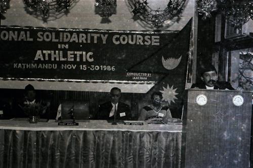 President of Nepal Olympic Committee Sharad Chandra Shaha (right) delivering his opening remarks during the IOC Regional Solidarity Course (Athletics) in Kathmandu, Nepal (Nov 15, 1986).  President of Nepal Amateur Athletic Association Dwarikaram Bhagat Mathema (left) along with IAAF (International Amateur Athletics Federation) Experts are also present on the occasion