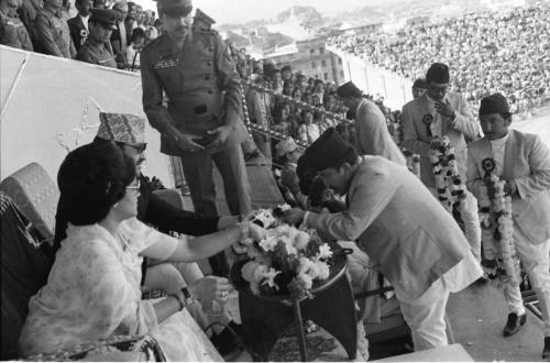 Their Majesties King Birendra and Queen Aishwarya receiving welcome garlands at the VVIP Pavilion, Dashrath Stadium by Member Secretary of the National sports council Sharad Chandra Shaha and Council members during the opening ceremony of 1st National Games, Kathmandu (2038 BS/1982 AD)